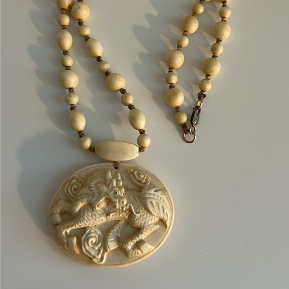 Vintage hand carved dragon pendant